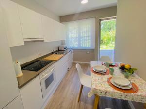 a kitchen with a table and a table and chairs at Casa Vacacional Galiana in Avilés