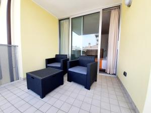 two chairs and a table in a room at Residence Hotel Hungaria in Grado