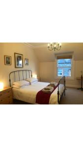 a bedroom with a large bed and a window at 4 bedroom townhouse Kirkcudbright in Kirkcudbright