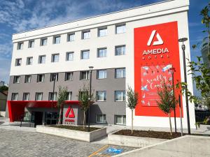 a large white building with aania hotel sign on it at Amedia Milano, Trademark Collection by Wyndham in Milan