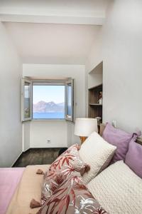 a bedroom with a bed and a large window at Résidence de la Tour in Piana