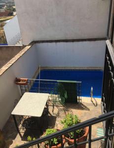 a balcony with a table and a swimming pool at Comfortable Villa in Puebla de Don Rodrigo with Private Pool in Puebla de Don Rodrigo