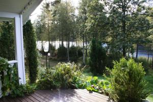 a view of a garden from the porch of a house at Björsjödal Lake House's in Gothenburg