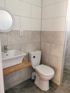 a bathroom with a toilet and a sink at Domki u Iwonki -brązowy in Niechorze