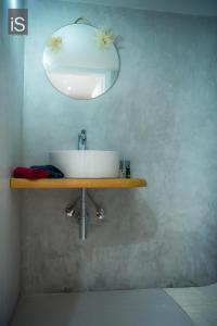 a bathroom with a sink and a mirror on a shelf at MY HOME in Áno Lekhónia