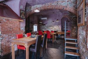 a dining room with wooden tables and red chairs at Un Angelo Alla Mia Tavola in Sarzana