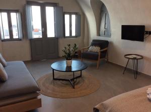 a living room with a couch and a table at Almyra Oia Suites in Oia