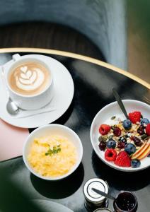 a table topped with bowls of food next to a cup of coffee at Le Parisis - Paris Tour Eiffel in Paris