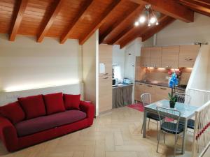 a living room with a red couch and a table at La Casetta di Baveno in Baveno