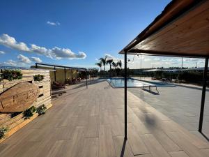 eine große Terrasse mit Pool und Sonnenschirm in der Unterkunft Casa Acito in Stornara