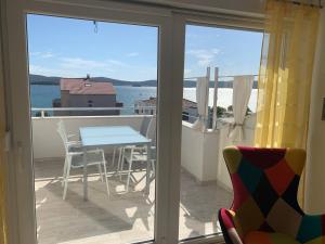 a view of a balcony with a table and chairs at Apartments Lucie in Biograd na Moru