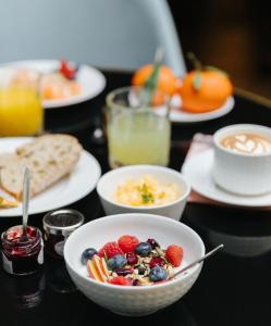 a table with plates of breakfast foods and drinks at Le Parisis - Paris Tour Eiffel in Paris