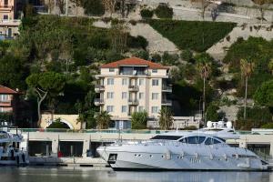 a white boat is docked at a marina at Sole Mare in Ventimiglia