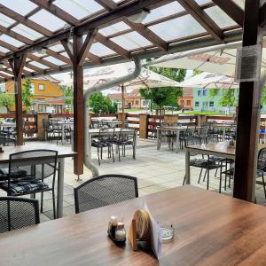an outdoor patio with tables and chairs and tablesktop at Penzion Maděřič in Moravský Žižkov +12 photos