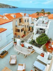 an apartment balcony with a view of the ocean at Castel Abaso Boutique Apartments in Andros