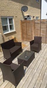 a patio with chairs and a table and a table and chairs at SUNSHINE ROOM in Colchester