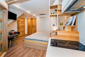 a small bedroom with a bed and a desk at Ground Floor Gem (city centre) in Rovinj