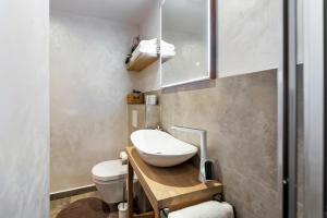 a small bathroom with a toilet and a sink at Ground Floor Gem (city centre) in Rovinj +11 photos