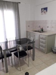 a kitchen with a table and chairs and a sink at Villa Tania R in Firostefani