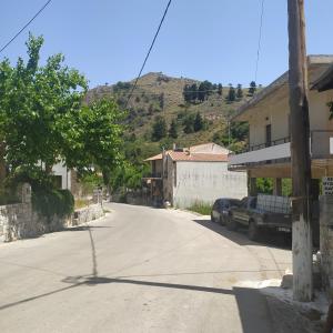 an empty street in a small town with a mountain at Therisso Rooms in Thérison +22 photos