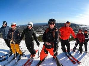 a group of people posing for a picture on a ski slope at Stötens Stugor & Lägenheter in Stöten