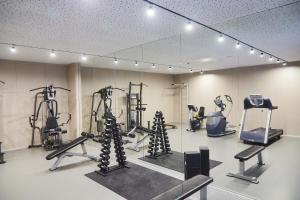 a gym with several tread machines and a mirror at SHAMBALA WELLNESS CLUB in Rozhny