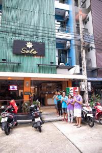 a group of people standing in front of a building at Hotel Sole in Patong Beach