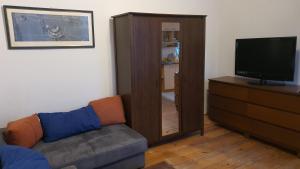 a living room with a couch and a television at Apartamenty Oliwa in Gdańsk