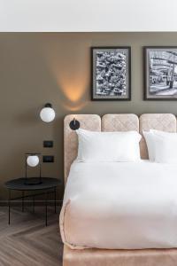 Een bed of bedden in een kamer bij Hotel Tocq