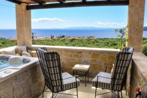 a patio with a view of the ocean from a house at Polismata - Private Residences in Kardamyli