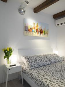 a white bedroom with a bed and a table at Residence SS Giovanni e Paolo in Venice