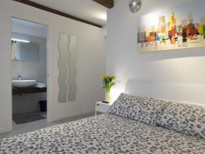 a bedroom with a bed and a bathroom with a sink at Residence SS Giovanni e Paolo in Venice
