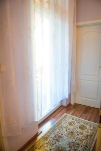 a room with a window and a rug and a door at 2 on seven in Zagreb