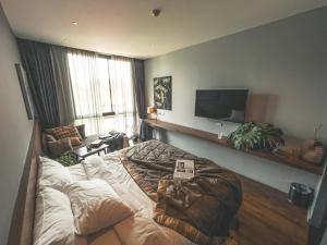 a living room with a large bed in the middle at Spice House Chiang Mai in Chiang Mai