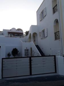 un edificio blanco con una puerta delante en Villa Tania R en Firostefani