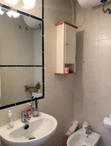 a bathroom with a sink and a mirror at Lomas de Sancti Petri in Cádiz +14 photos