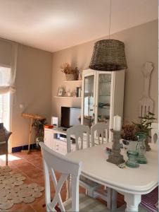 a dining room with a white table and chairs at Lomas de Sancti Petri in Cádiz