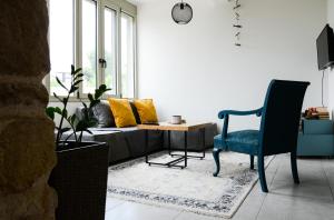 een woonkamer met een bank en een stoel bij Deus Apartments_ Athens Airport in Spáta
