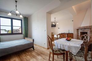 a living room with a dining room table and a dining room at Porto in Karwia