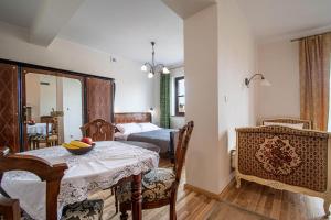 a room with a table and chairs and a bedroom at Porto in Karwia