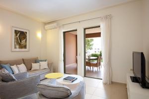 a living room with a couch and a tv at A & C Homes in Plakias