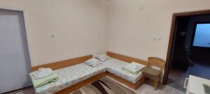 a small room with a bed and a chair at Guest House Kukera in Pavel Banya