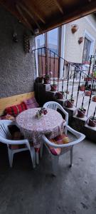 a table and chairs on a balcony with a table and a table and chairs at Guest House Kukera in Pavel Banya