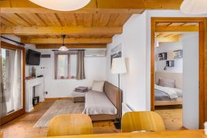 a living room with a couch and a bed at Sunset Hill Vendégház Zebegény in Zebegény +16 photos