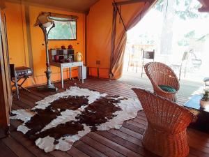 a living room with a rug on the floor at Le Lodge de Loge & Broc in La Possonnière +9 photos