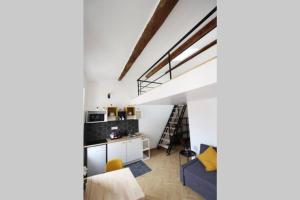 a loft conversion with a kitchen and a living room at LOFT LE BER'AMAR L'ESTAQUE in Marseille