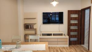 a living room with a tv on the wall at Apartment Central Park in Gabrovo