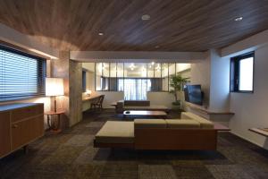 a living room with a couch and a television at Hotel Vintage Kagurazaka Tokyo in Tokyo