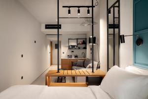 a bedroom with a bed and a table and a couch at Bob W Athens Akadimia in Athens