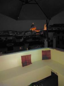 a view of a city at night from a building at Locanda Stella in Florence